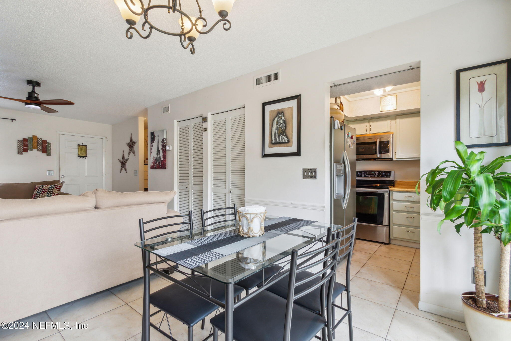 1004 Kettering Way Orange Park, FL 32073 - Photo 15 of 29 a dining room with furniture potted plants and wooden floor