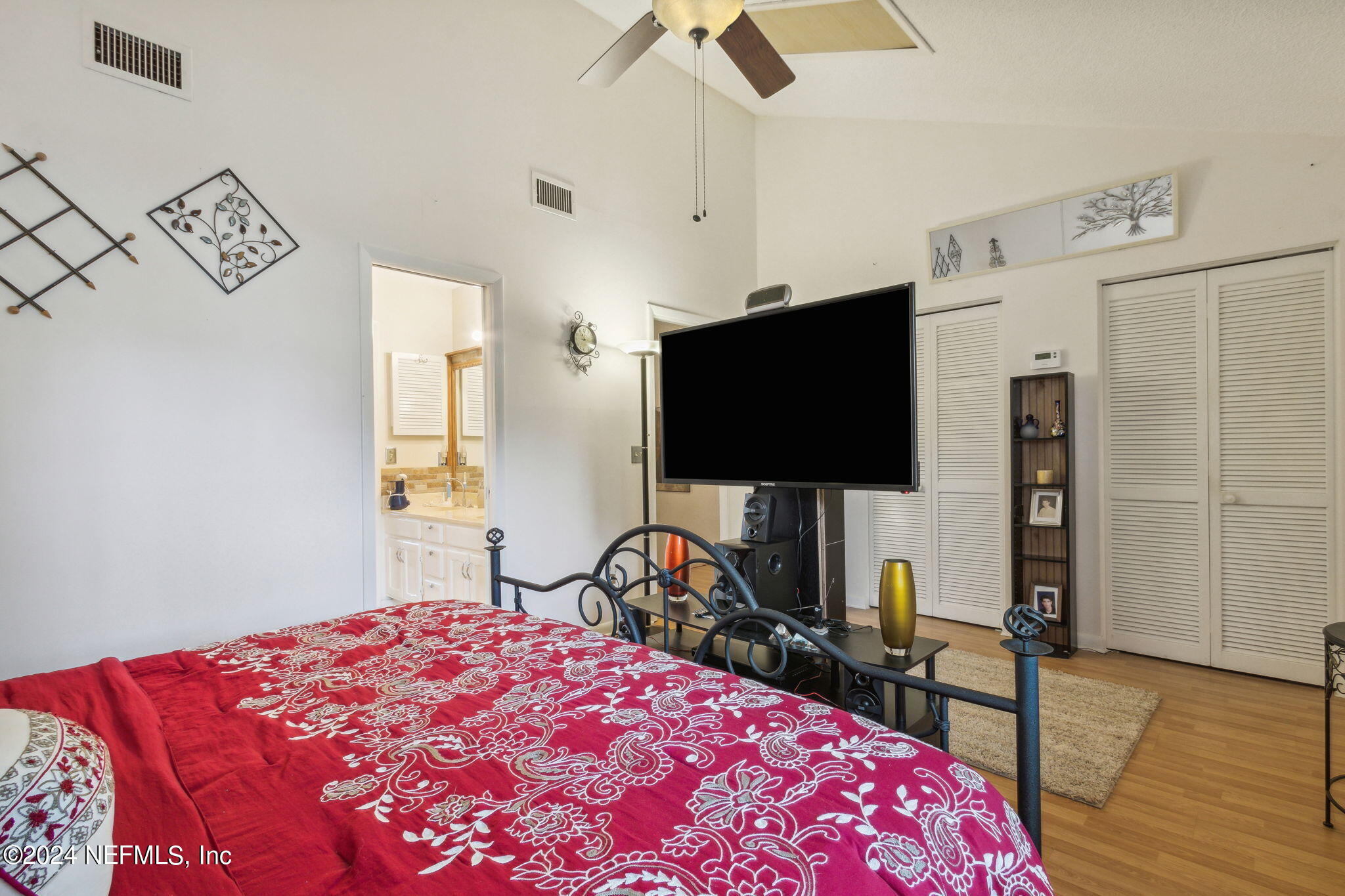 1004 Kettering Way Orange Park, FL 32073 - Photo 17 of 29 a bedroom with a bed and a flat screen tv