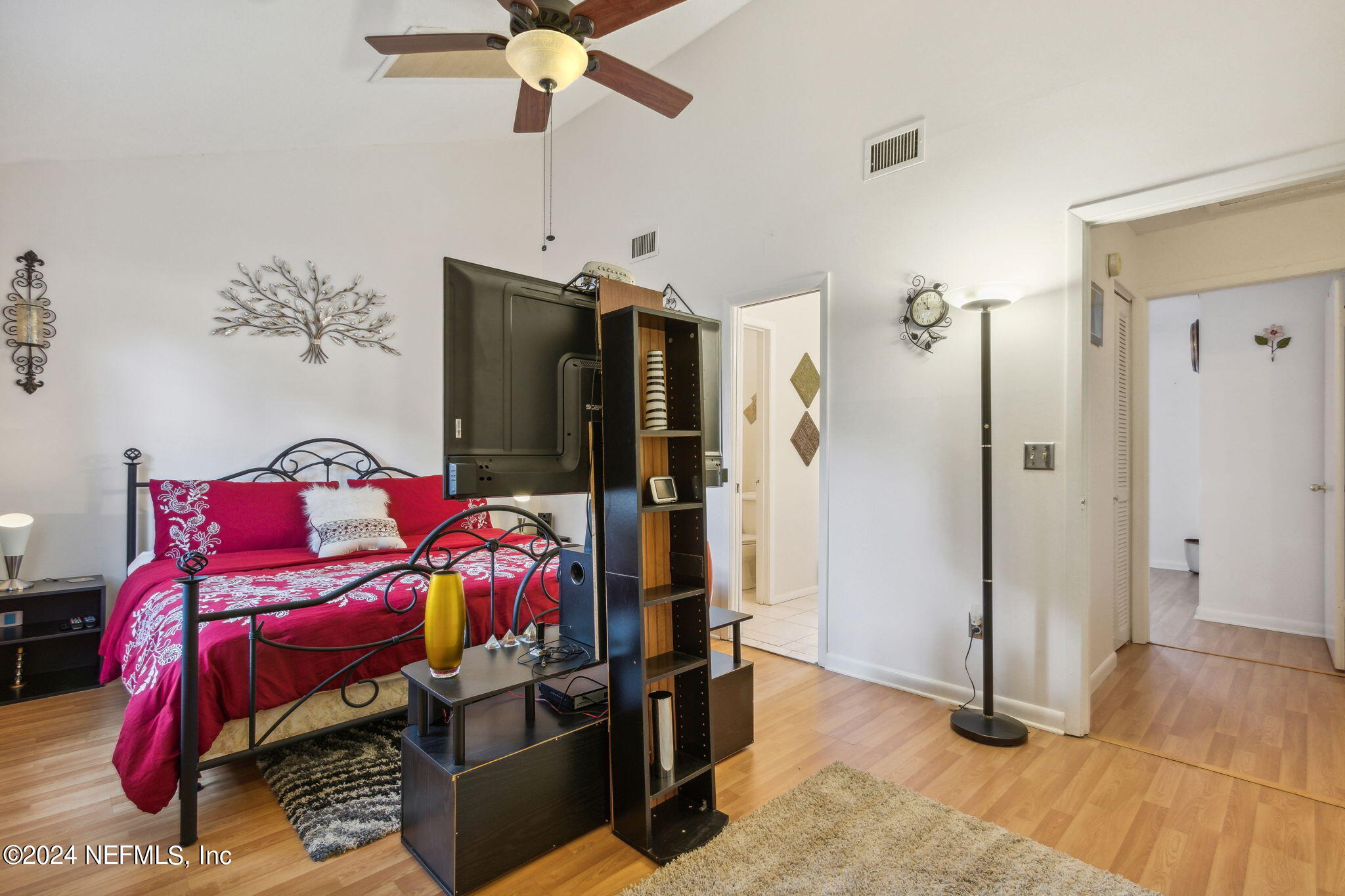1004 Kettering Way Orange Park, FL 32073 - Photo 18 of 29 a bedroom with furniture and a chandelier