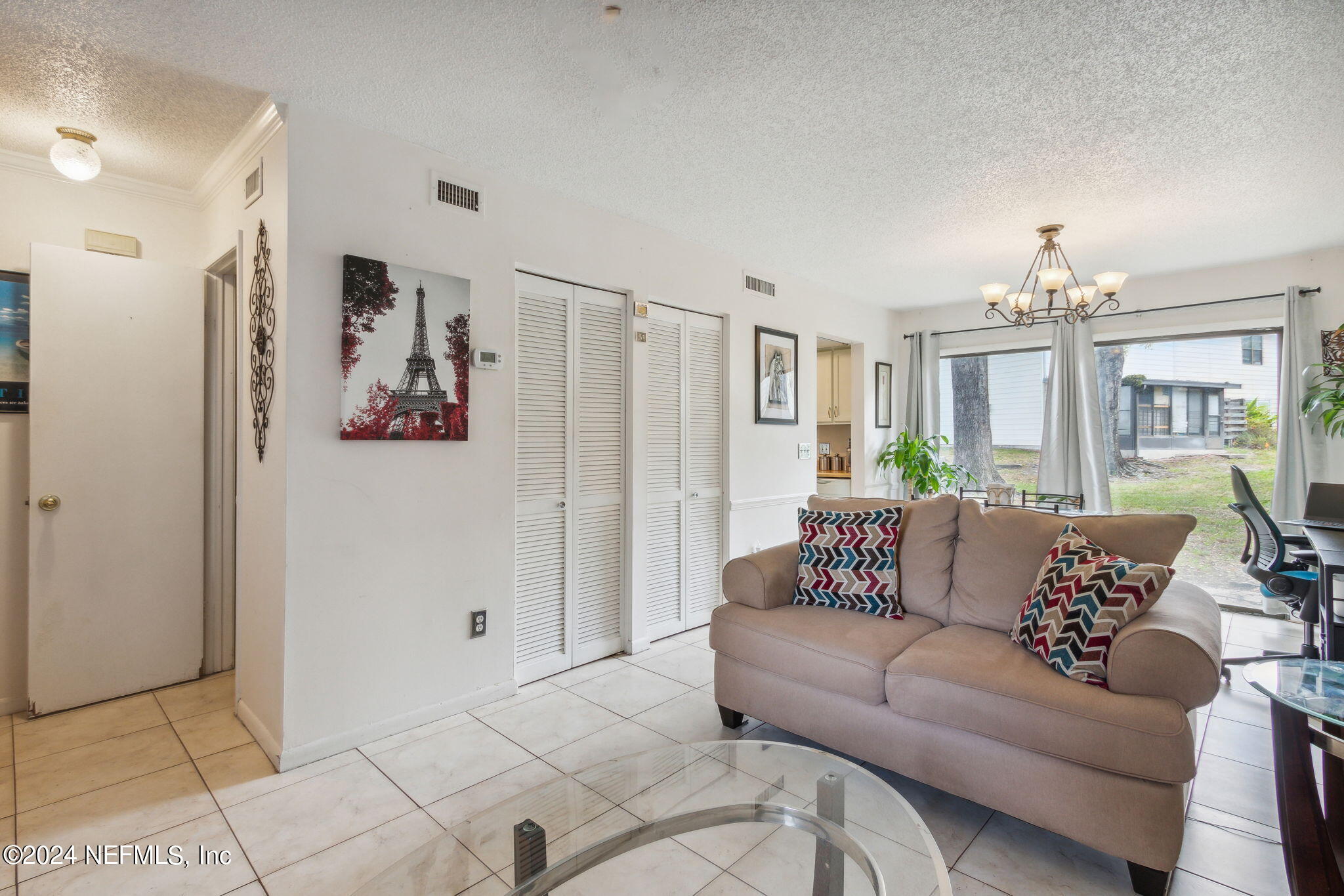 1004 Kettering Way Orange Park, FL 32073 - Photo 5 of 29 a living room with furniture and a chandelier