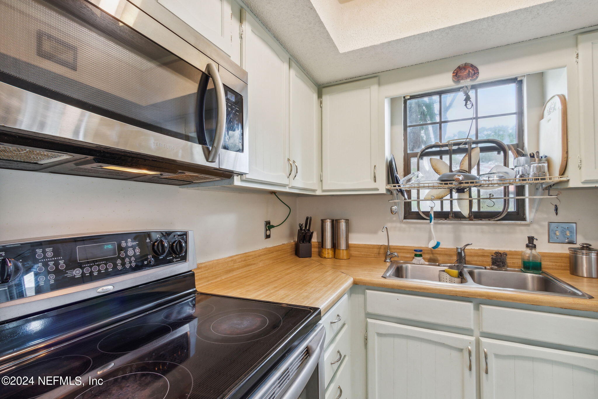 1004 Kettering Way Orange Park, FL 32073 - Photo 10 of 29 a kitchen with stainless steel appliances a sink and cabinets