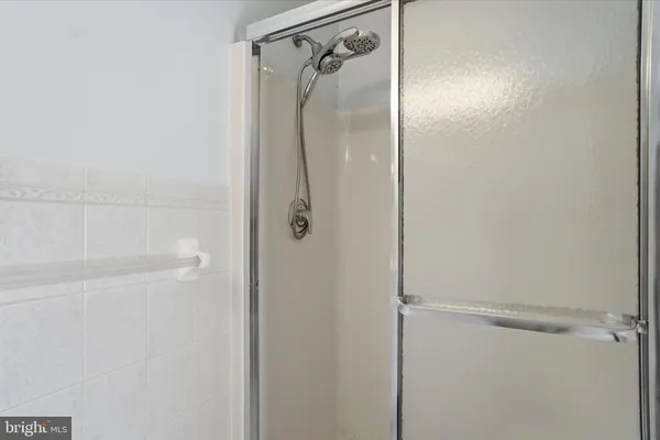 a bathroom with a glass shower door