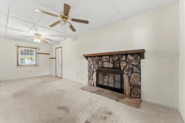 a view of an empty room with a fireplace