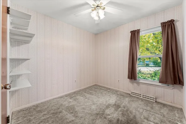 a view of an empty room with a window