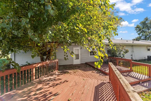 a balcony with wooden floor and fence