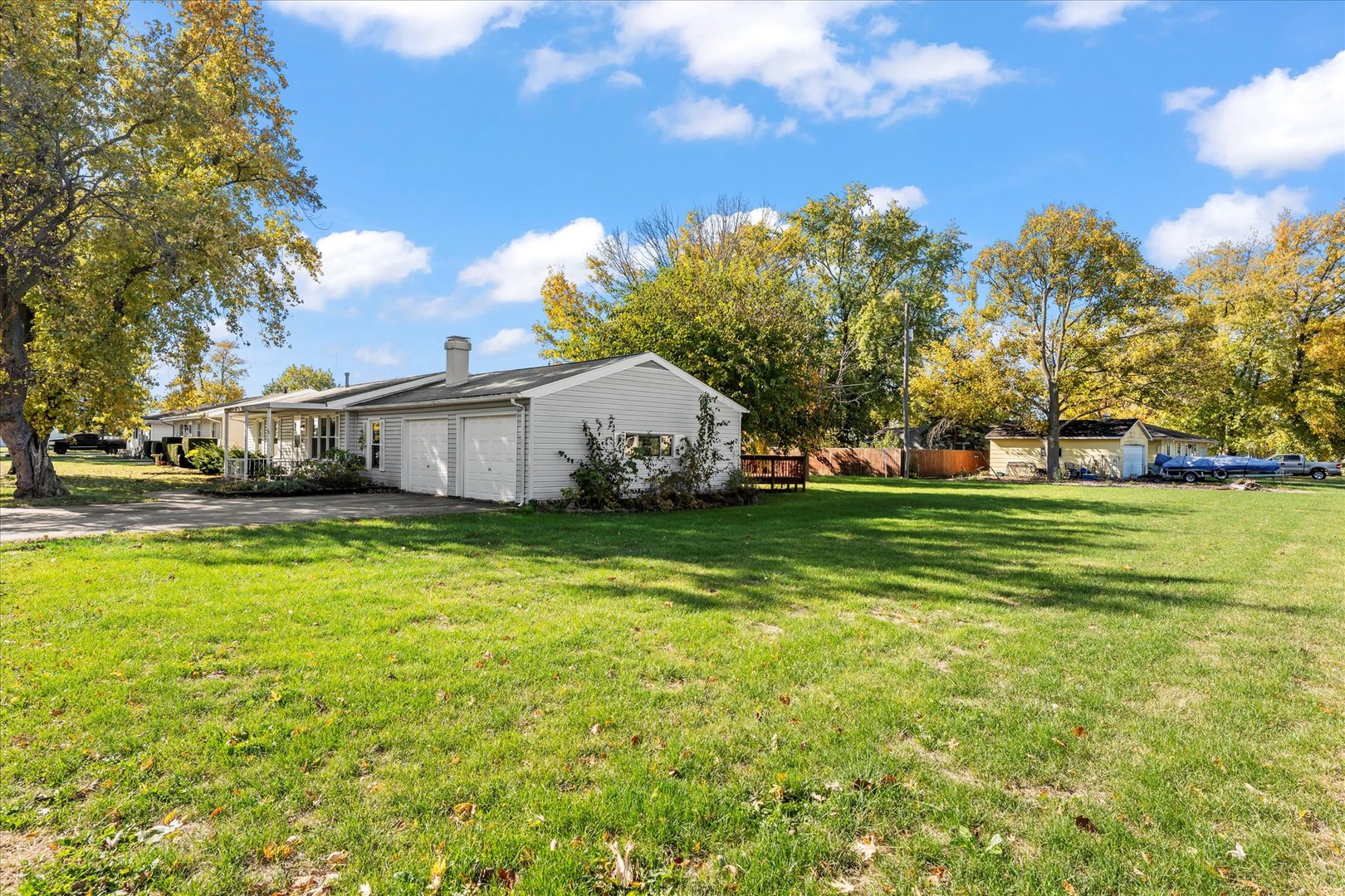 211 South Main Street Argenta, IL 62501 - Photo 26 of 32 a front view of a house with a garden and trees