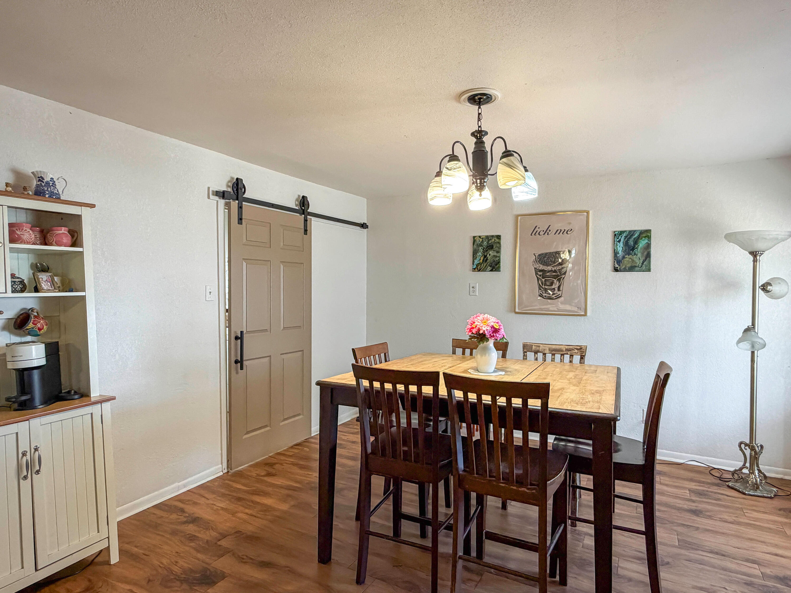 3221 Emory Street Lubbock, TX 79415 - Photo 3 of 15 a view of a dining room with furniture and wooden floor