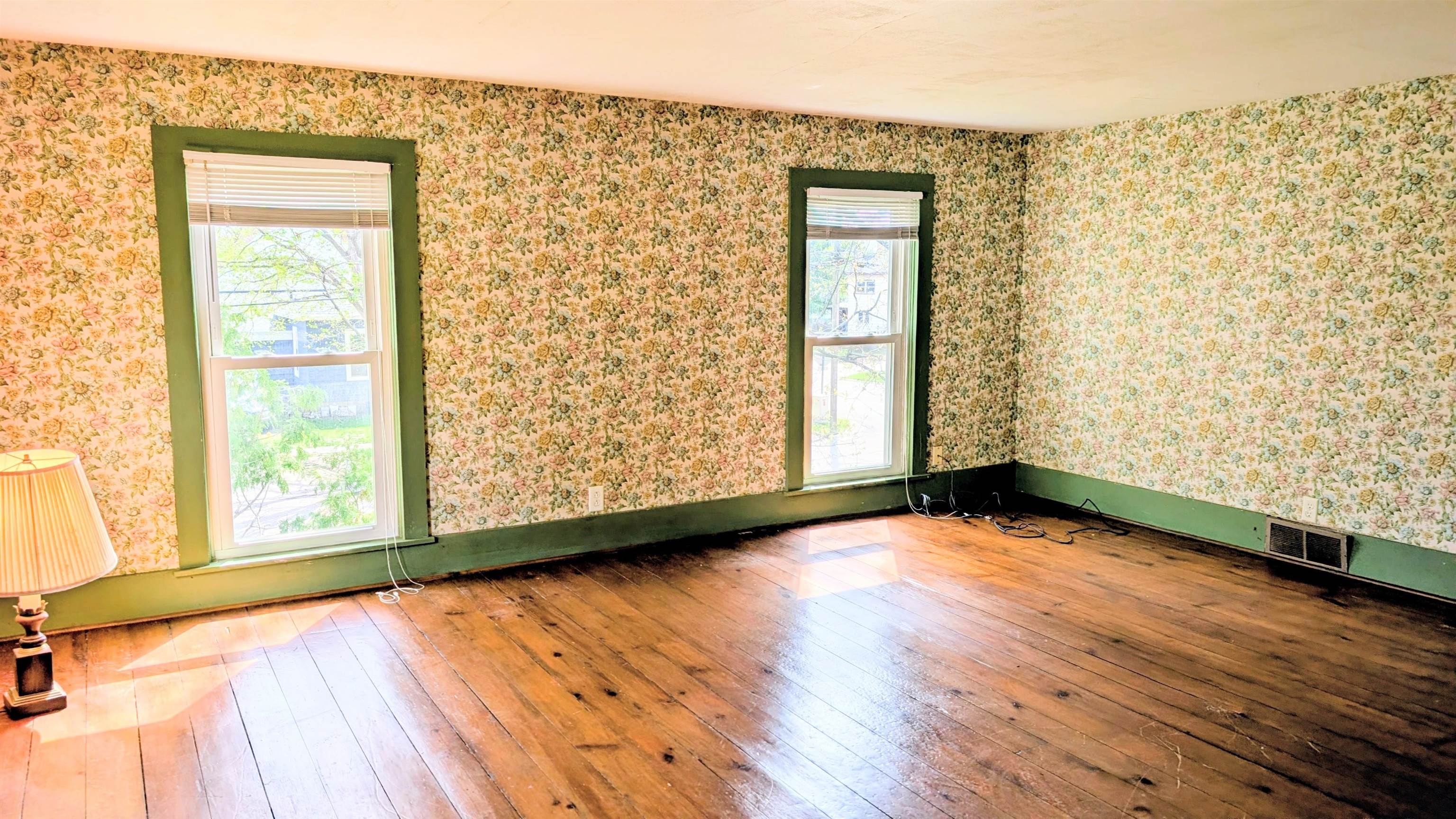 210 South 7th Street Oregon, IL 61061 - Photo 12 of 21 a view of an empty room with wooden floor and a window