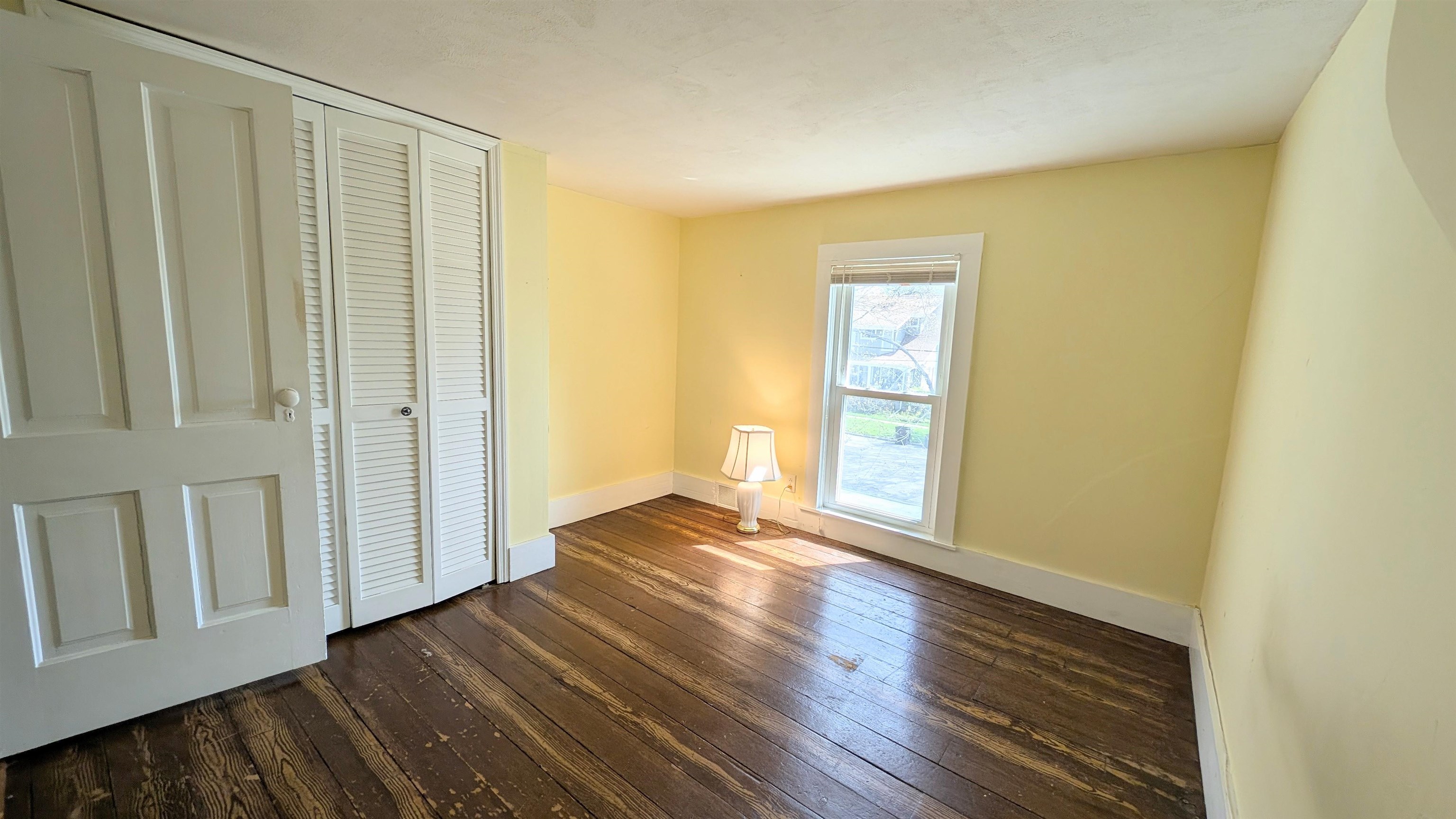 210 South 7th Street Oregon, IL 61061 - Photo 14 of 21 a view of an empty room with wooden floor and a window