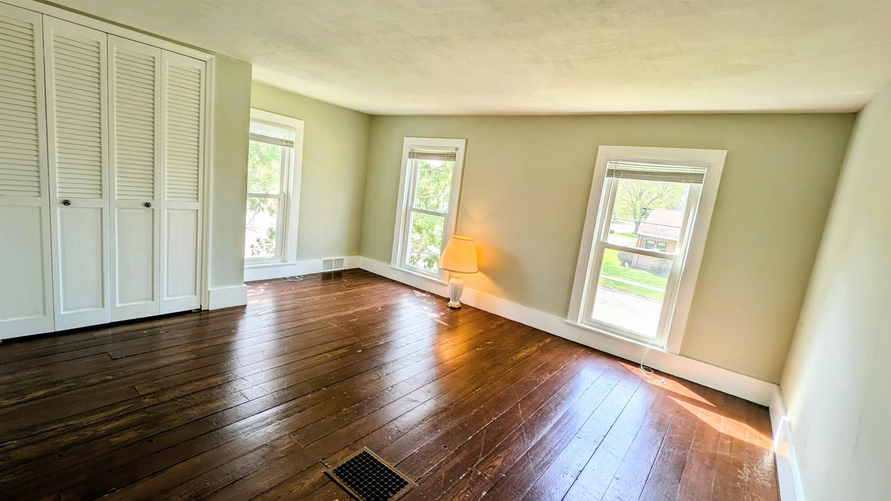 210 South 7th Street Oregon, IL 61061 - Photo 15 of 21 a view of an empty room with wooden floor and a window