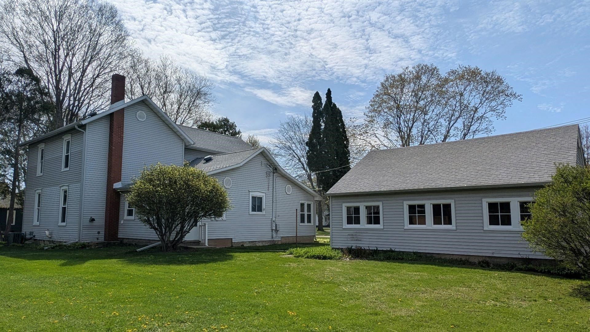 210 South 7th Street Oregon, IL 61061 - Photo 20 of 21 a front view of a house with a garden and yard