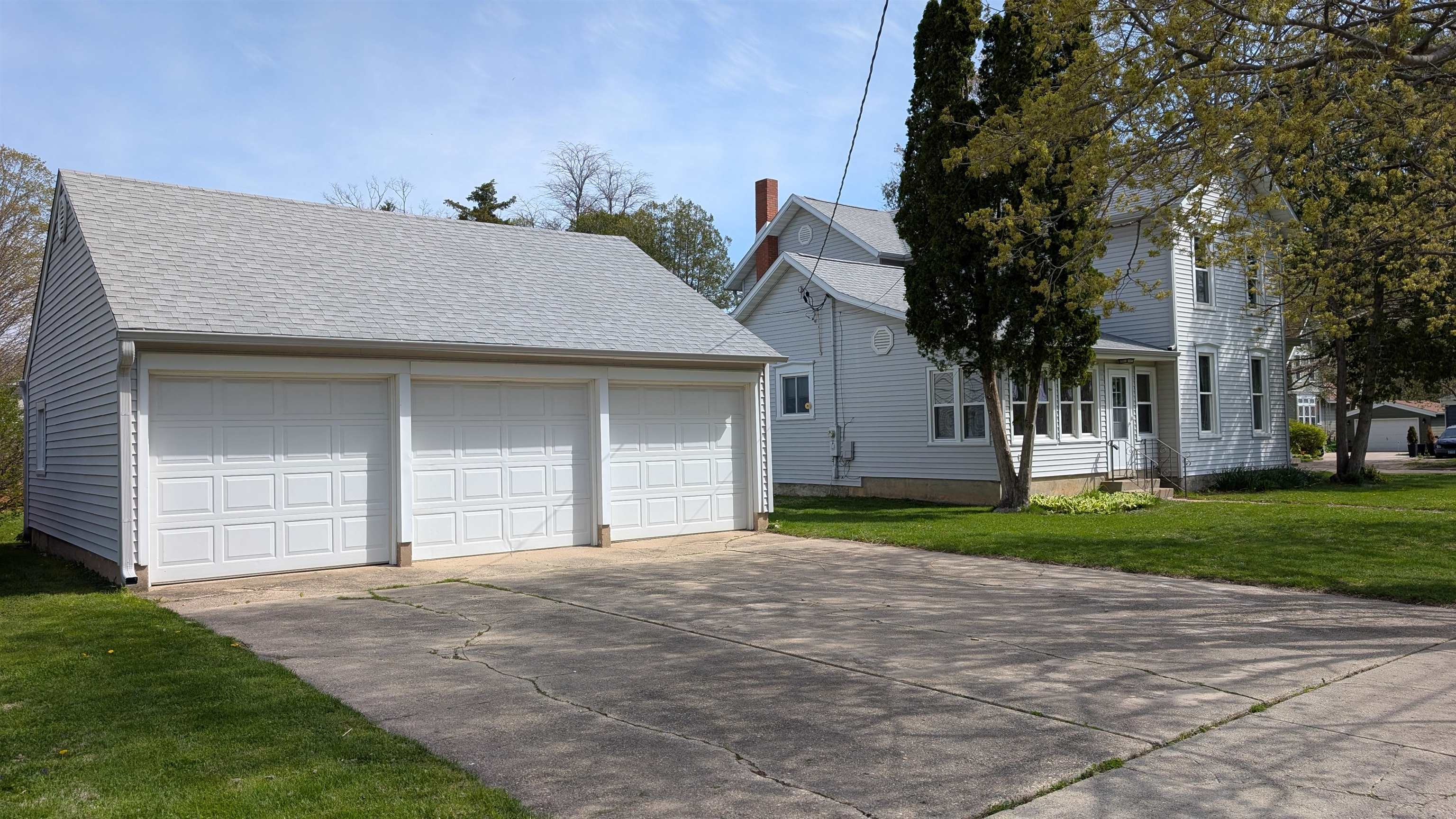 210 South 7th Street Oregon, IL 61061 - Photo 2 of 21 a front view of a house with a yard and garage