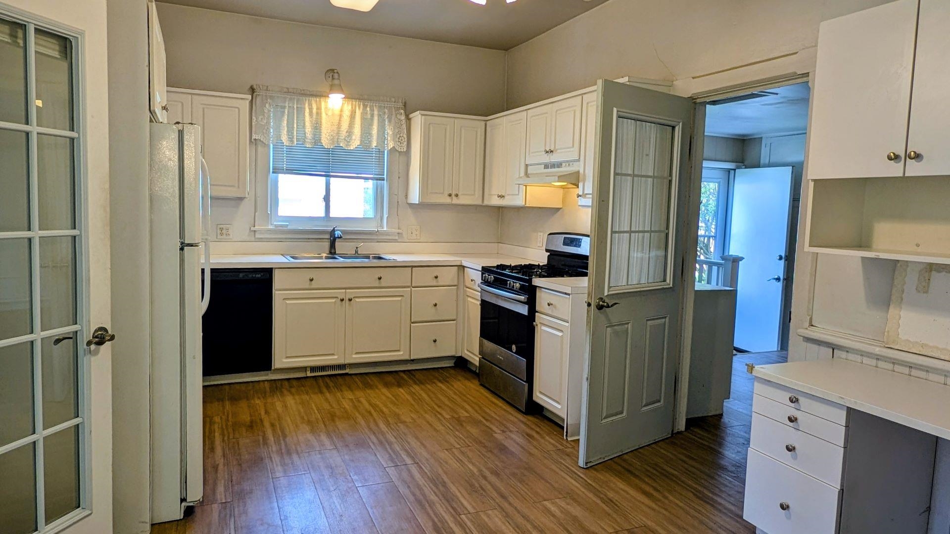 210 South 7th Street Oregon, IL 61061 - Photo 3 of 21 a kitchen with a sink a counter top space stainless steel appliances and cabinets