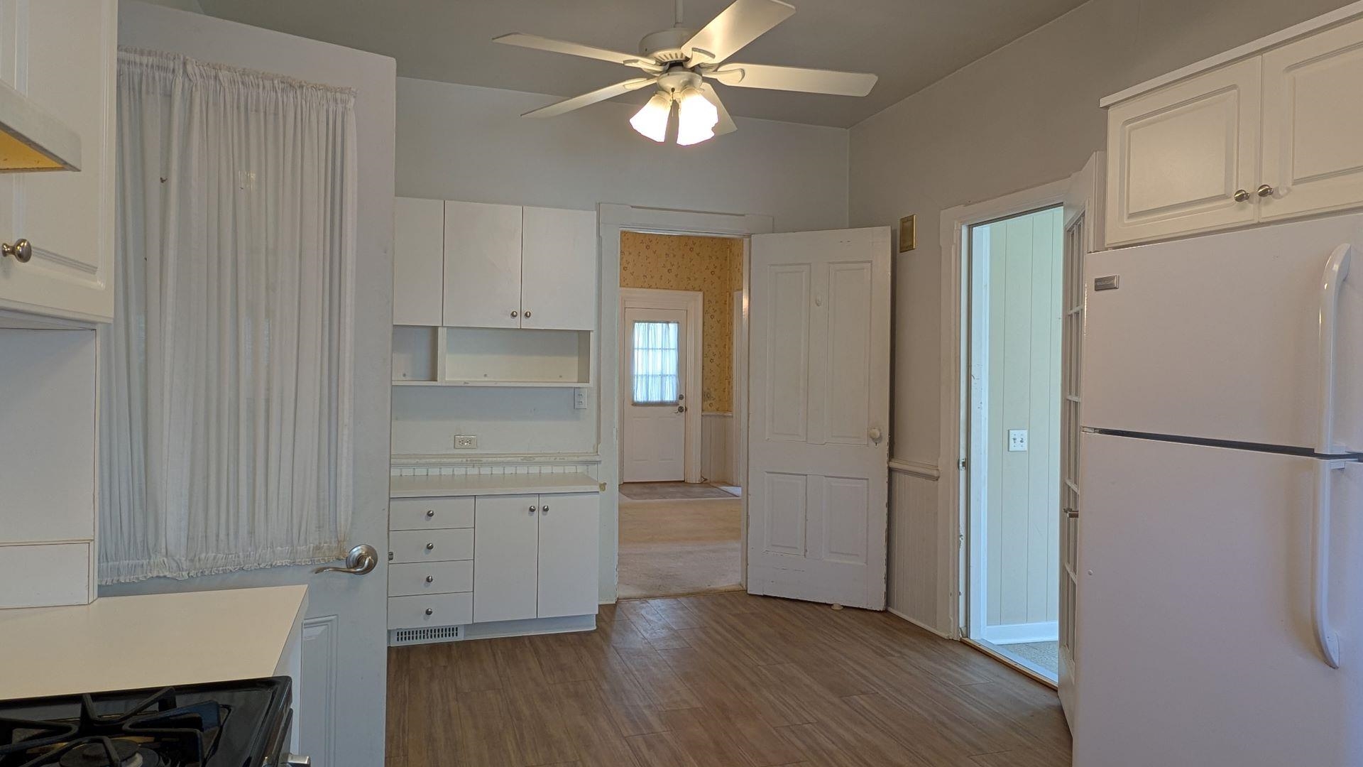 210 South 7th Street Oregon, IL 61061 - Photo 9 of 21 a view of a kitchen with a refrigerator and wooden floor