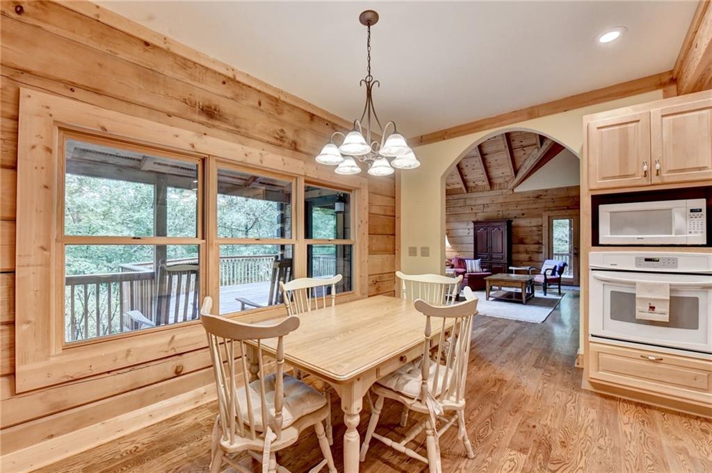 82 Walnut Grove Lane Tiger, GA 30576 - Photo 26 of 88 a view of a dining room with furniture large windows and wooden floor