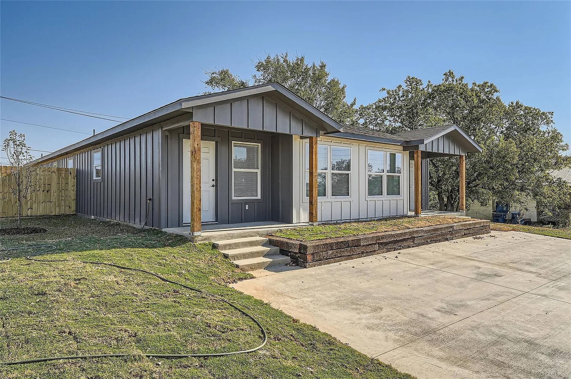 View of front facade featuring board and batten siding and covered porch
