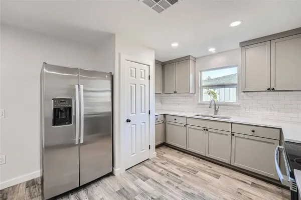 a kitchen with stainless steel appliances granite countertop a refrigerator and a sink
