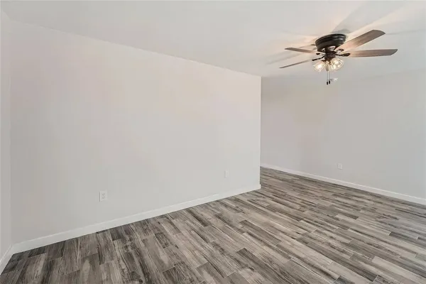 a view of a room with wooden floor