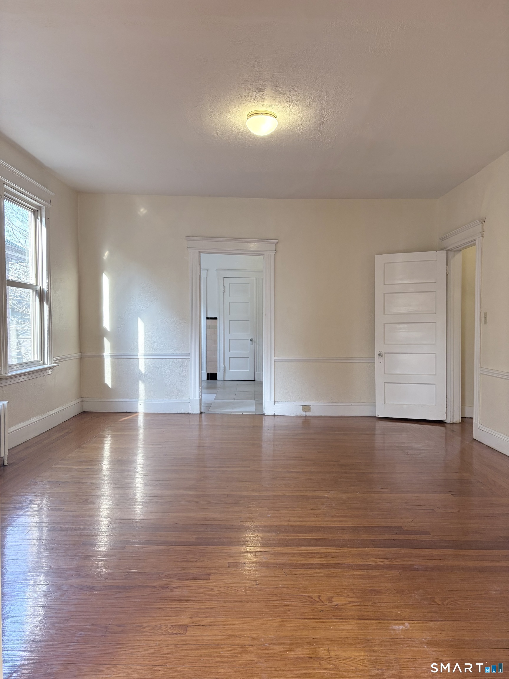 787 Elm Street, Unit 2 New Haven, CT 06511 - Photo 5 of 16 a view of empty room with wooden floor and fan