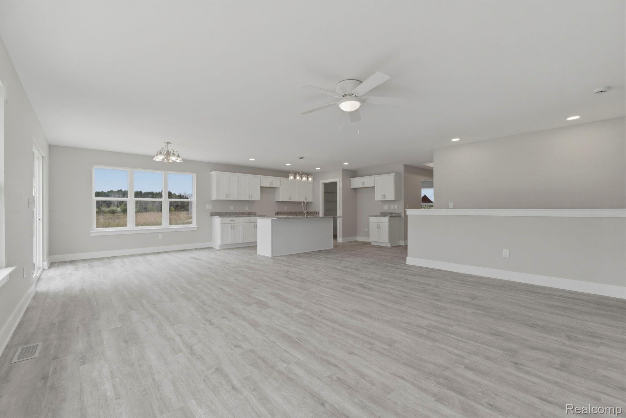 2281 Baltimore Davison, MI 48423 - Photo 11 of 26 Unfurnished living room featuring a chandelier, light wood-type flooring, and ceiling fan