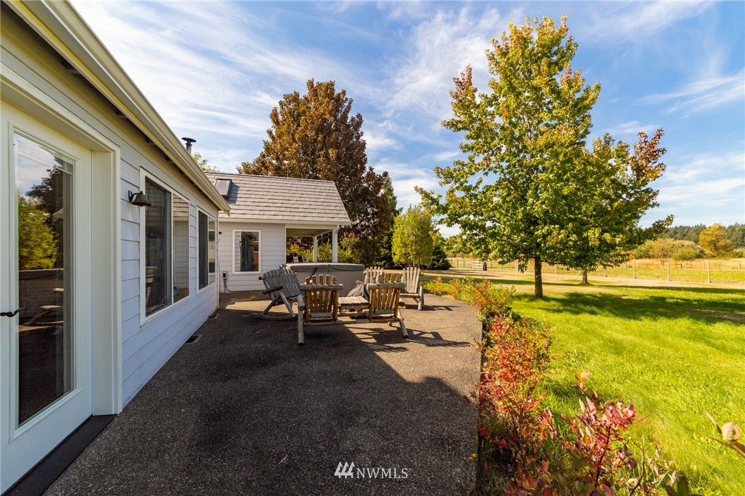 13729 Littlerock Road Southwest Rochester, WA 98579 - Photo 22 of 35 a view of swimming pool with outdoor seating and trees in the background