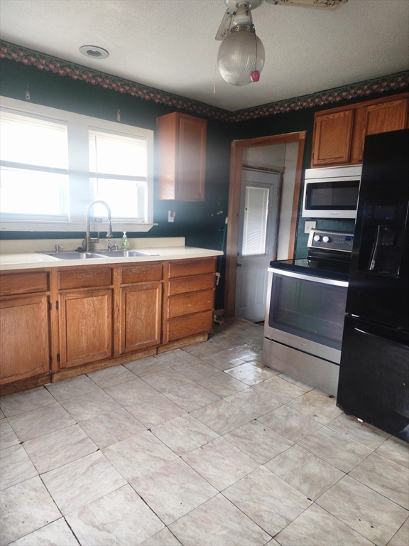 2 Alice Street Montague, MA 01376 - Photo 10 of 18 a large kitchen with stainless steel appliances a large counter top