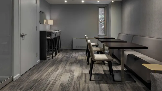 a view of a room with furniture and wooden floor