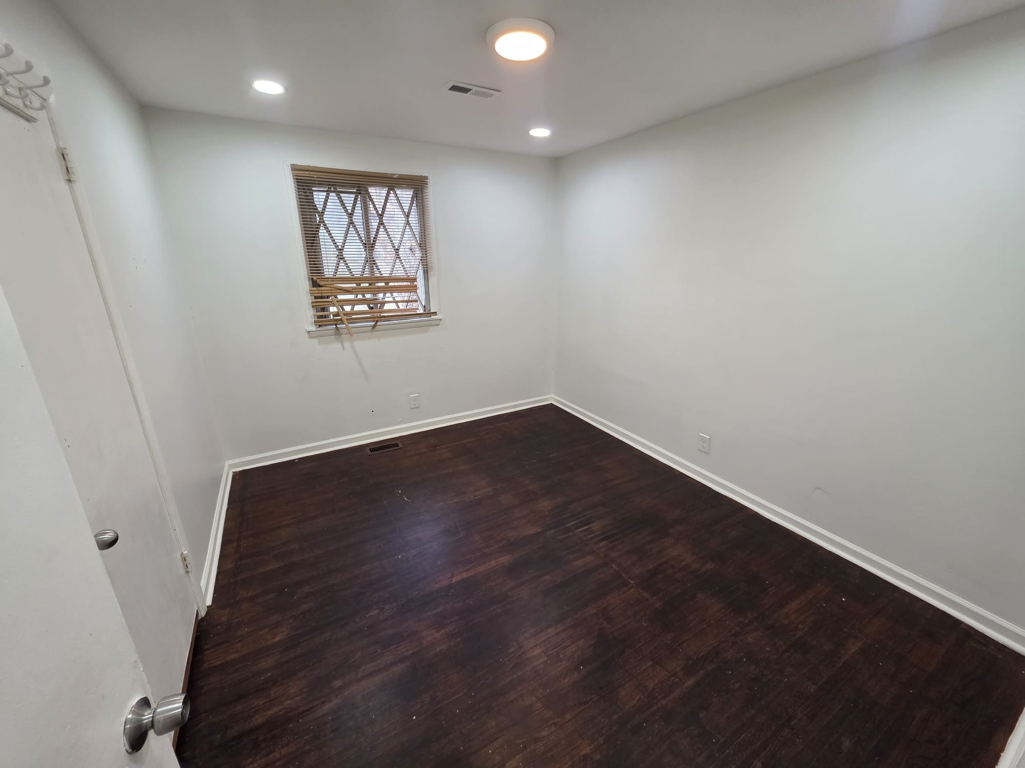 353 Elysian Fields Road, Unit A Nashville, TN 37211 - Photo 13 of 16 an empty room with wooden floor and windows