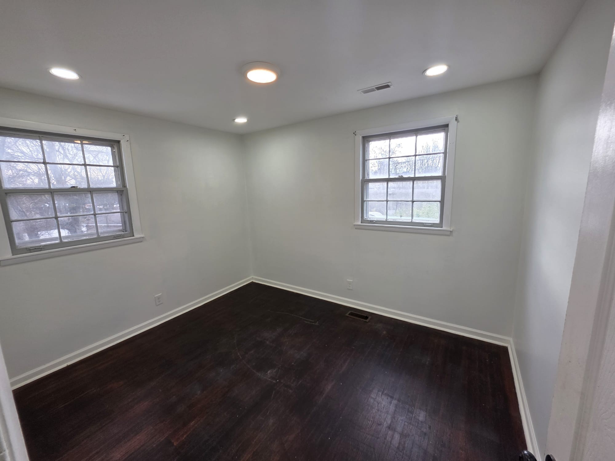 353 Elysian Fields Road, Unit A Nashville, TN 37211 - Photo 8 of 16 an empty room with wooden floor and windows