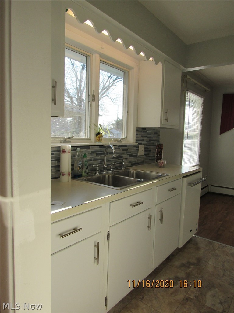 5910 Granger Road Ashtabula, OH 44004 - Photo 2 of 23 Cute, galley style kitchen offers practicality, new flooring, cabinet hardware, glass tile backsplash nice natural light.