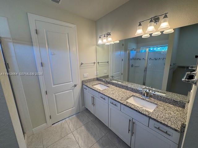 3917 Mahogany Lane Hollywood, FL 33021 - Photo 11 of 16 a bathroom with a granite countertop sink a large mirror and a shower