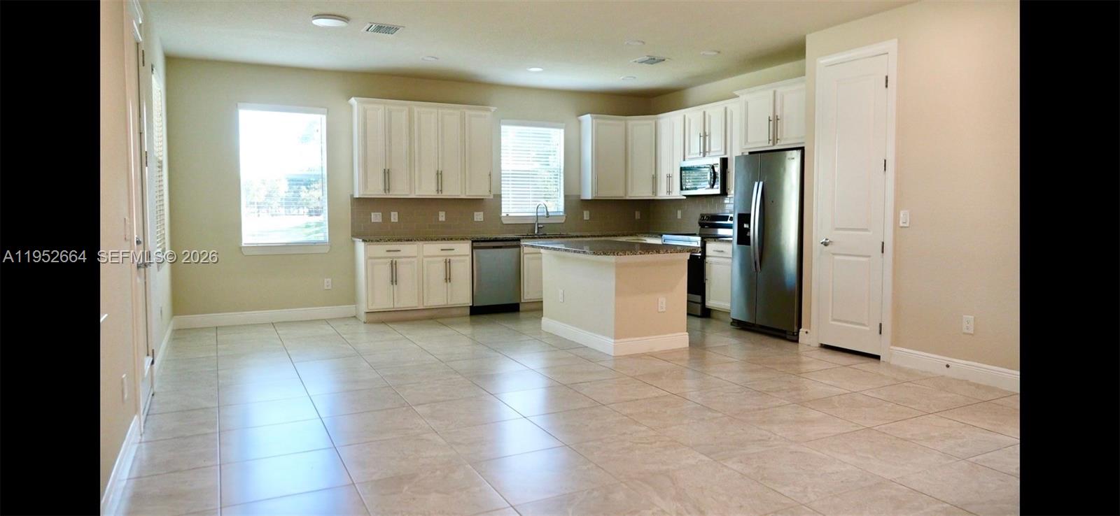 3917 Mahogany Lane Hollywood, FL 33021 - Photo 3 of 16 a kitchen with stainless steel appliances granite countertop a refrigerator and a stove top oven