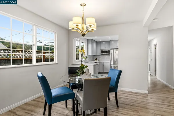 a dining room with furniture and wooden floor