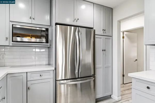 a kitchen with stainless steel appliances granite countertop a stove and a refrigerator