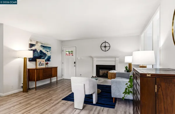 a living room with furniture a rug and a dining table