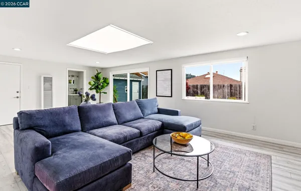 a living room with furniture a dining table and kitchen view