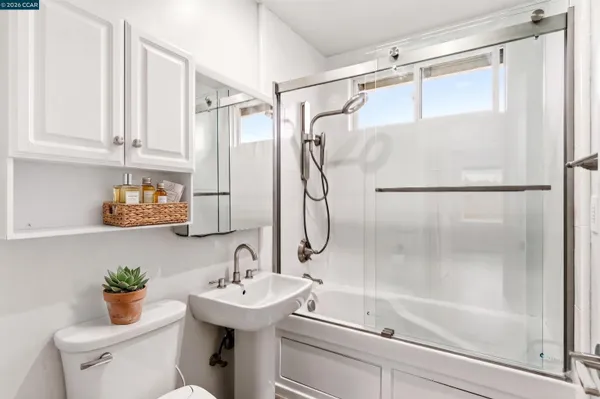 a bathroom with a sink a toilet and mirror
