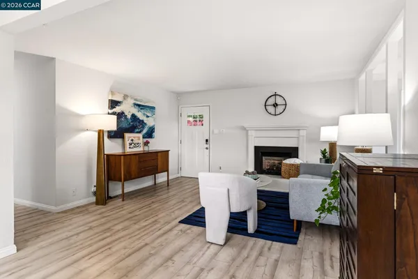 a living room with furniture a table and kitchen view