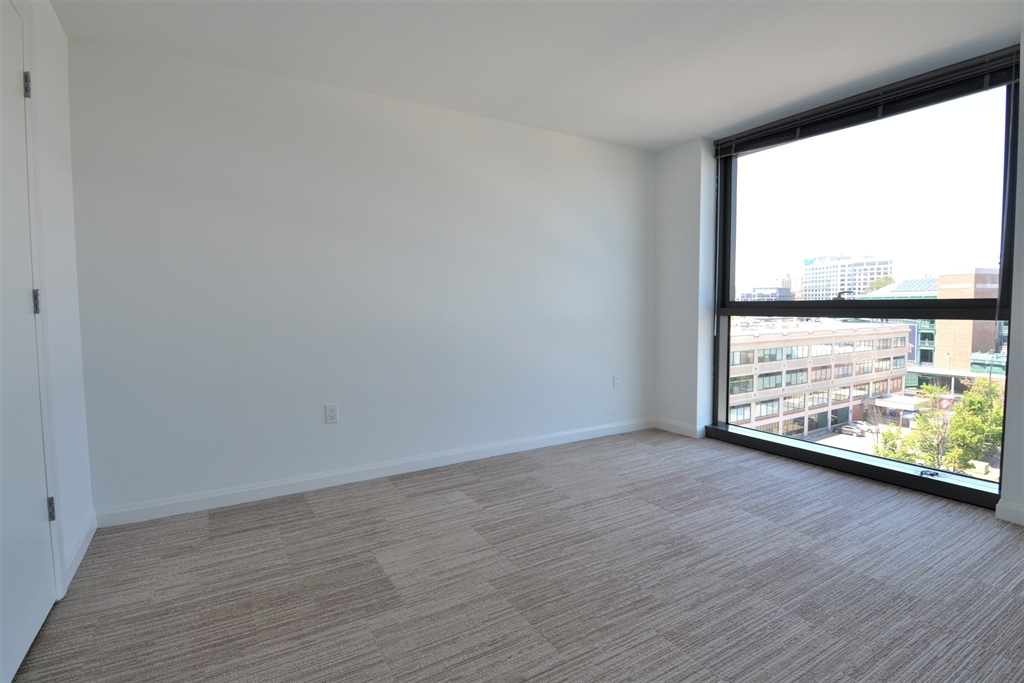 1282 Boylston Street, Unit 725 Boston, MA 02215 - Photo 16 of 18 an empty room with wooden floor and windows