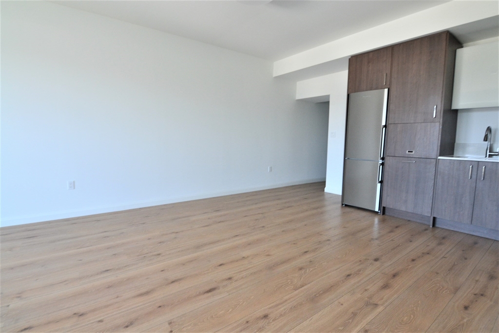 1282 Boylston Street, Unit 725 Boston, MA 02215 - Photo 17 of 18 an empty room with wooden floor and windows