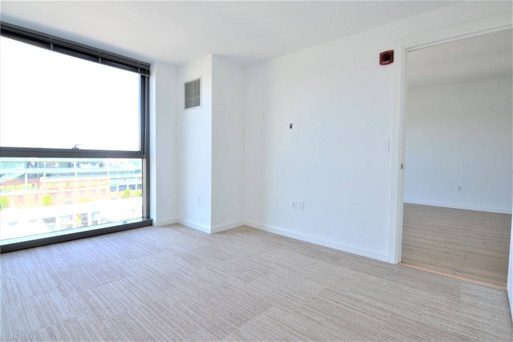 1282 Boylston Street, Unit 725 Boston, MA 02215 - Photo 18 of 18 an empty room with wooden floor and windows