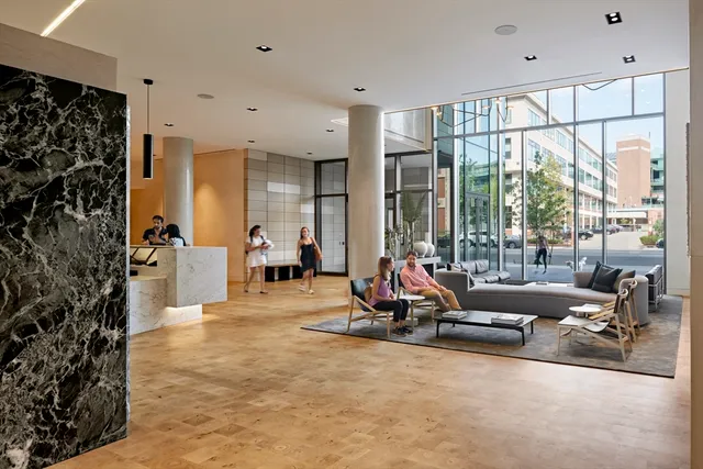 a living room filled with furniture gym equipment and a large window