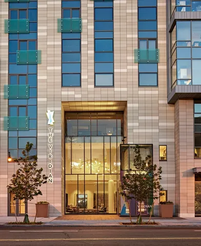 a view of a brick building with large windows