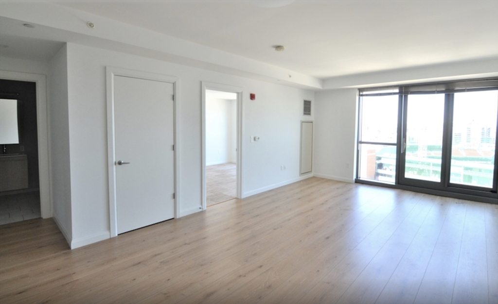 1282 Boylston Street, Unit 725 Boston, MA 02215 - Photo 10 of 18 a view of an empty room with a window and wooden floor