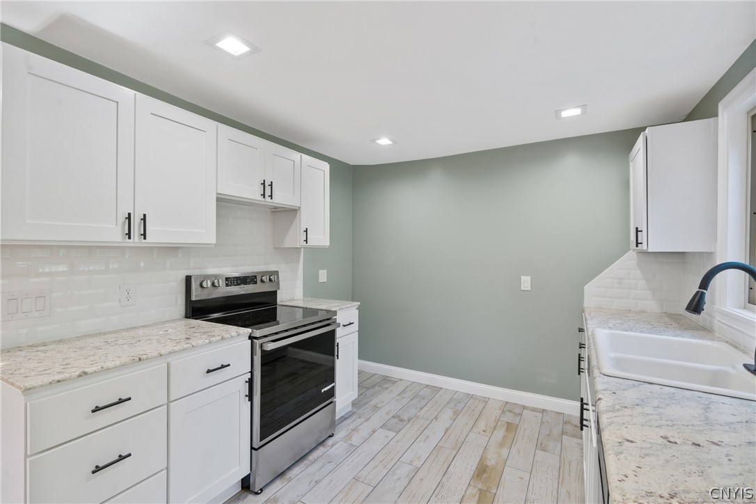 563 County Rte 12 Schroeppel, NY 13132 - Photo 12 of 39 The subway tile backsplash is both eye-catching and easy to clean after meal prep!