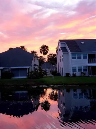 a view of a dining room with a table and chairs
