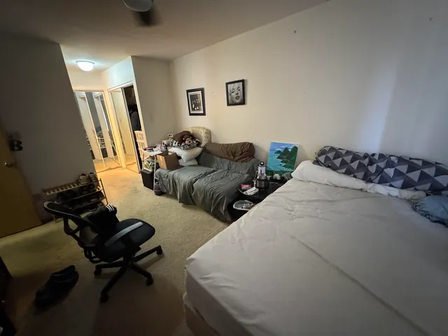 a bedroom with two beds and a couch