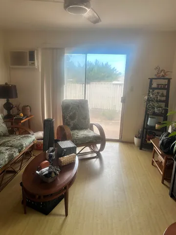 a living room with furniture and a floor to ceiling window