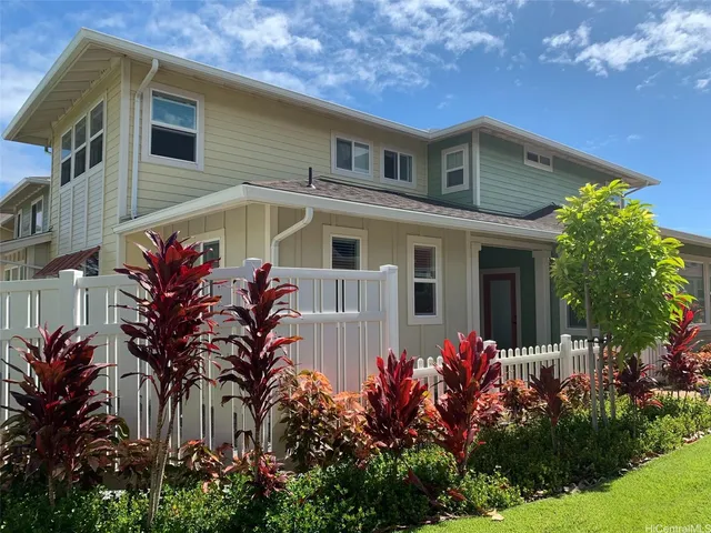 a view of a house with potted plants