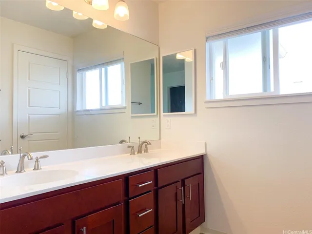 a bathroom with a double vanity sink and a mirror